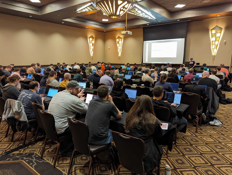 View of audience at a tech conference workshop from the rear of the room